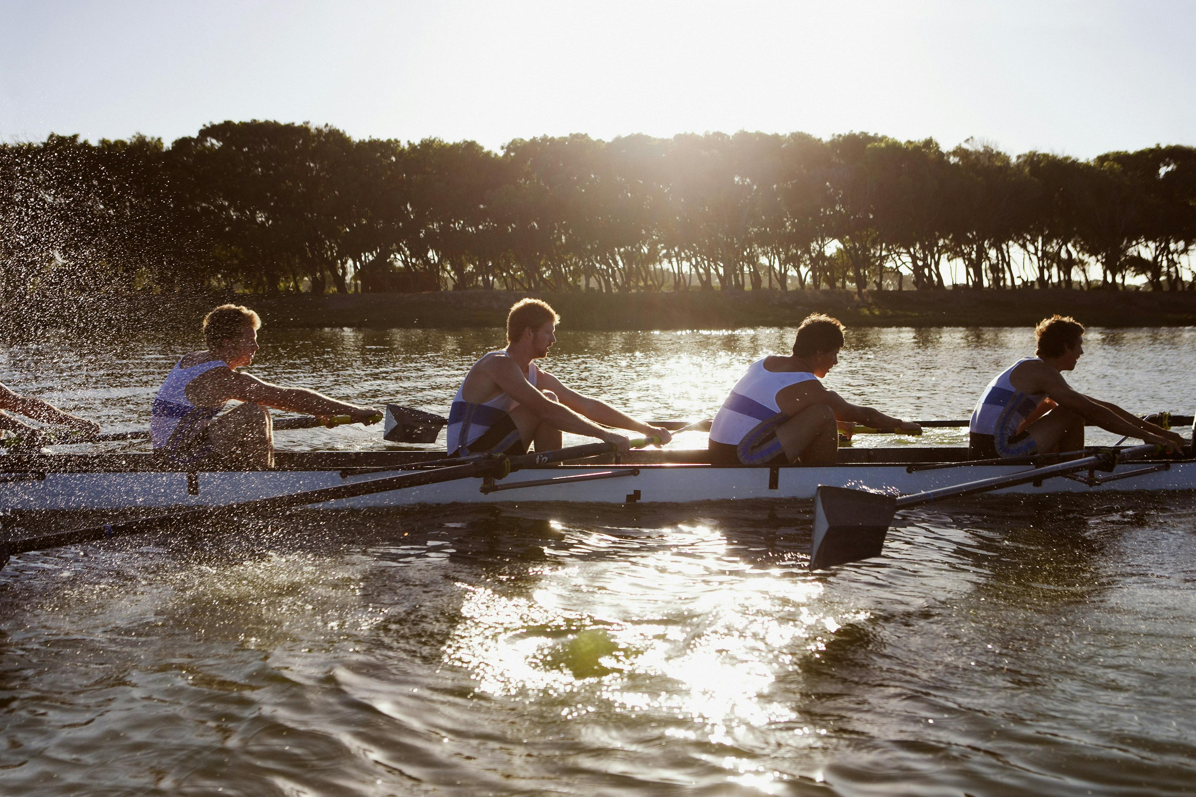 Group of people rowing on a river