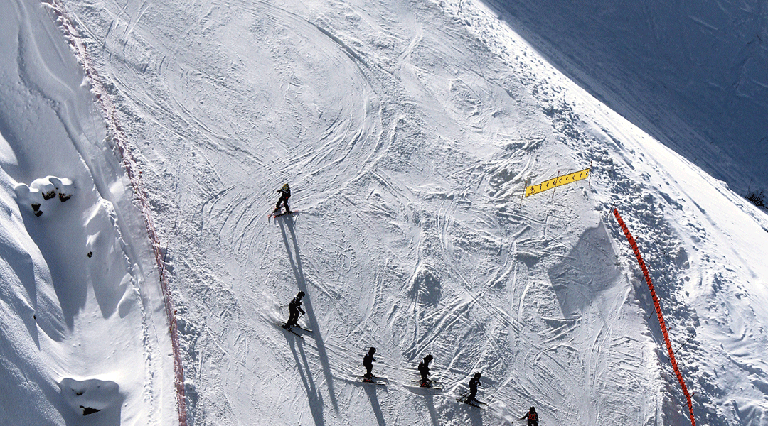 People skiing on snowy mountain